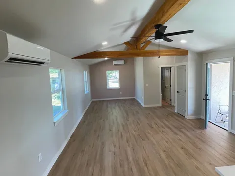 An empty room after a Kempt moving clean, floors and beam ceiling bare