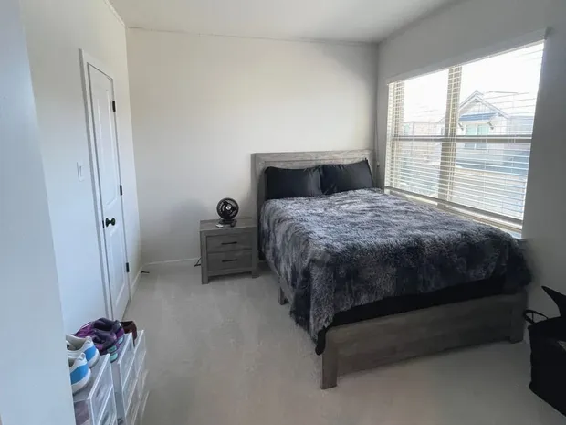 A tidy bedroom after a Kempt clean, bed made and blinds open